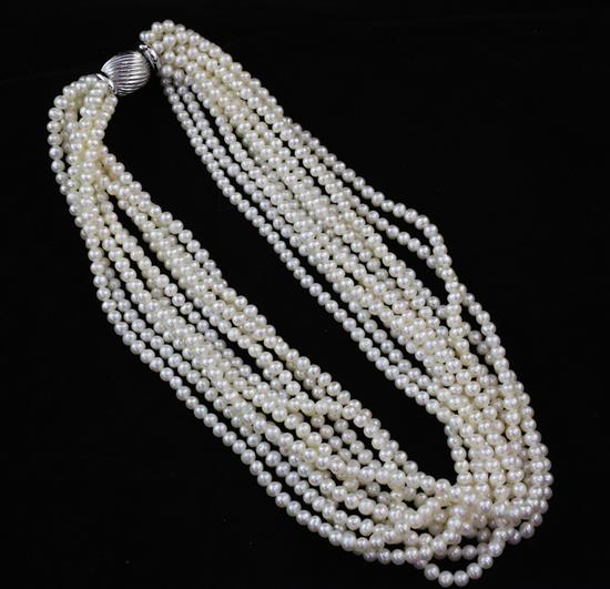 A modern multi strand cultured pearl necklace with a fluted 14ct white gold clasp, 17in.